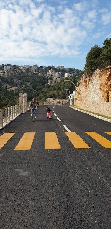Family cycling on the private road at the Ajaltoun villas project